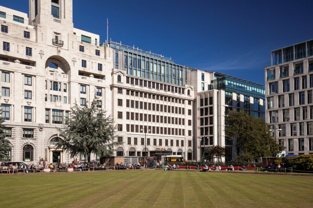 An exterior photography of Royal London House in autumn, with dark blue skies overhead and a neatly trimmed lawn in front.