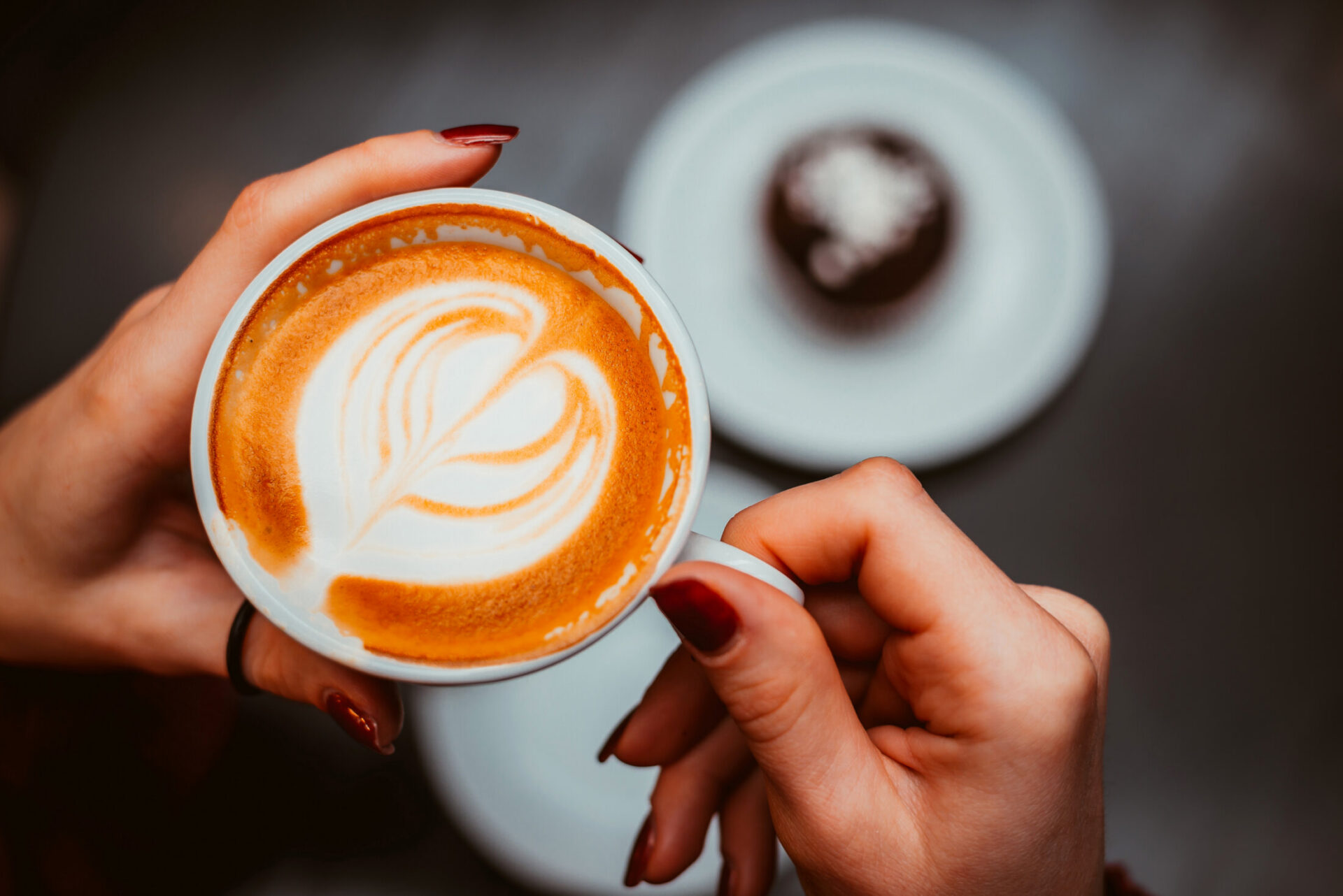 Relaxing women holding morning coffee in room